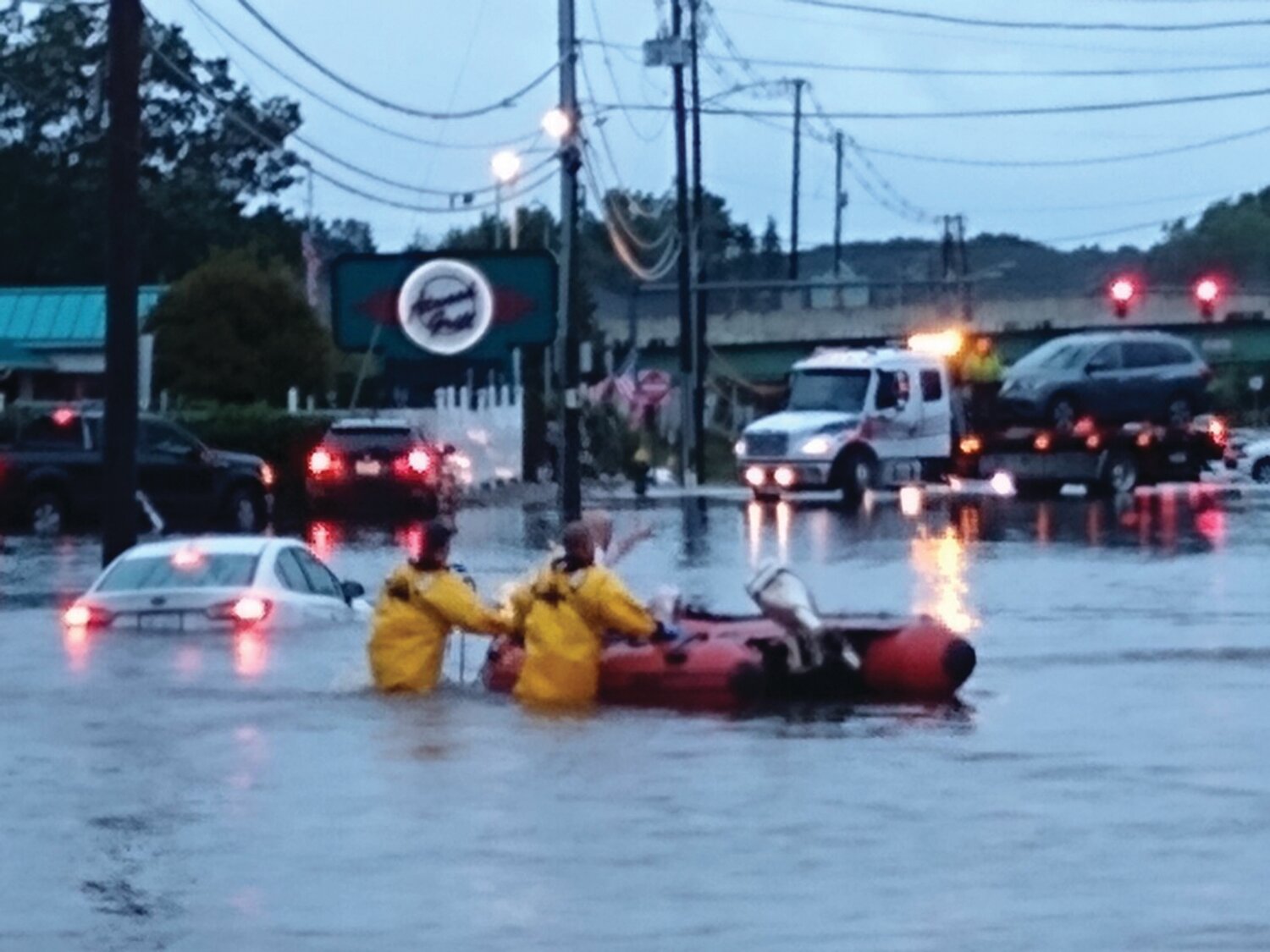 ATWOOD RIVER: A family was rescued by firefighters in a boat from their stuck vehicle in the middle of Atwood Avenue during Monday night’s widespread flooding in Johnston.